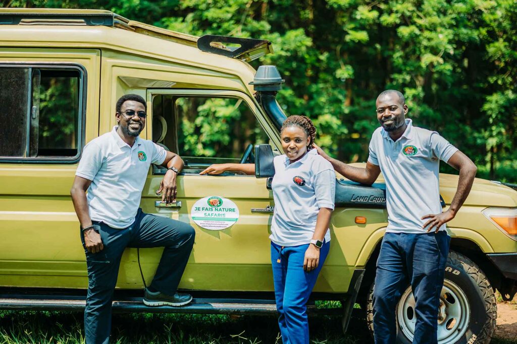 Je Fais Nature Safaris Staff standing on their 4 X 4 Landcruiser Vehicle